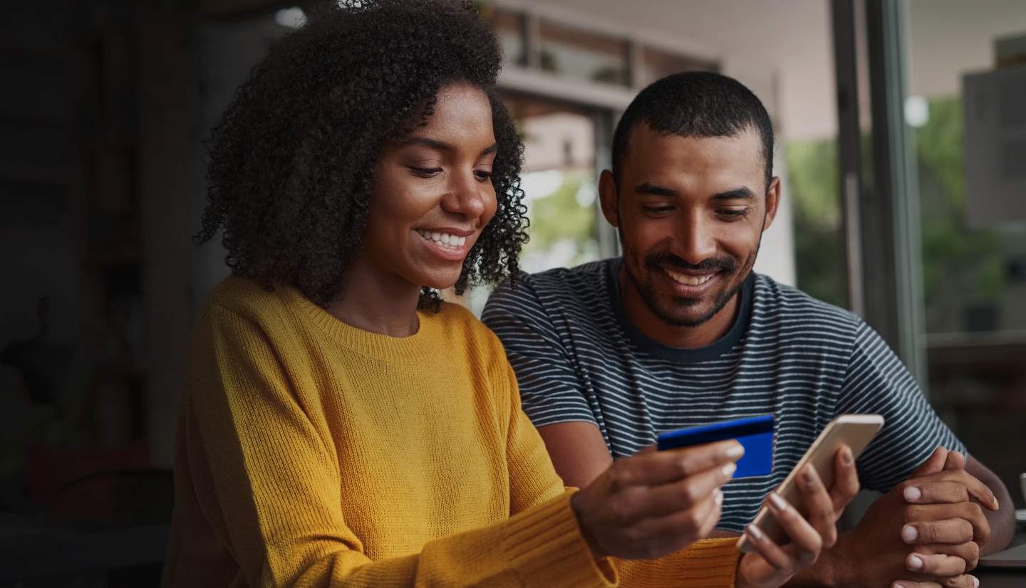Couple looking at a phone together, smiling